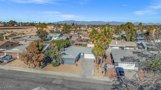 drone / aerial view featuring a residential view and a mountain view