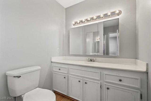 bathroom featuring toilet and vanity