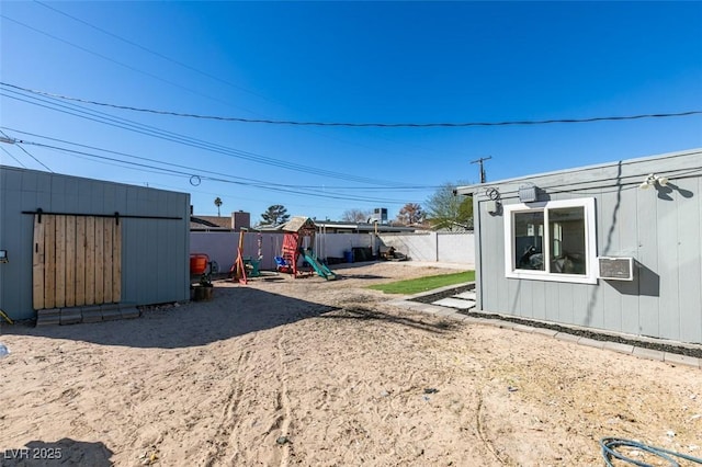 view of yard featuring fence and a playground