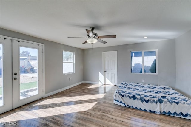 bedroom featuring access to exterior, baseboards, ceiling fan, and light wood finished floors