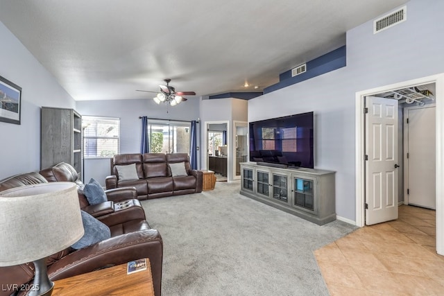 living area featuring lofted ceiling, tile patterned flooring, visible vents, and carpet