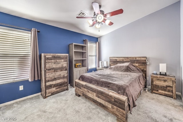 carpeted bedroom with a ceiling fan, visible vents, and baseboards