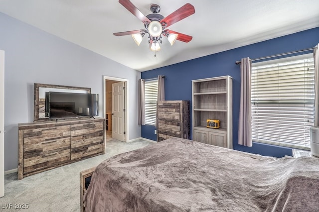 bedroom with carpet floors, lofted ceiling, baseboards, and a ceiling fan