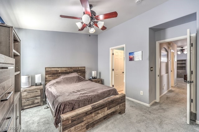 bedroom featuring light carpet, ceiling fan, and baseboards