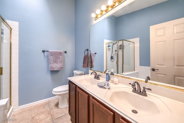 bathroom with tile patterned floors, a sink, toilet, and a shower stall