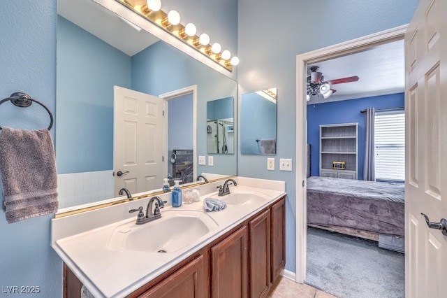 ensuite bathroom featuring a sink, double vanity, and connected bathroom