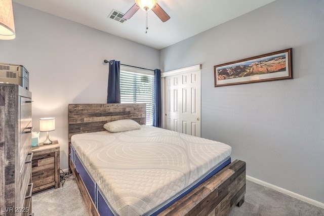 bedroom featuring baseboards, visible vents, a ceiling fan, carpet flooring, and a closet