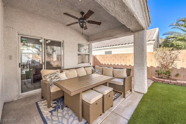 view of patio / terrace featuring ceiling fan, fence, and an outdoor living space