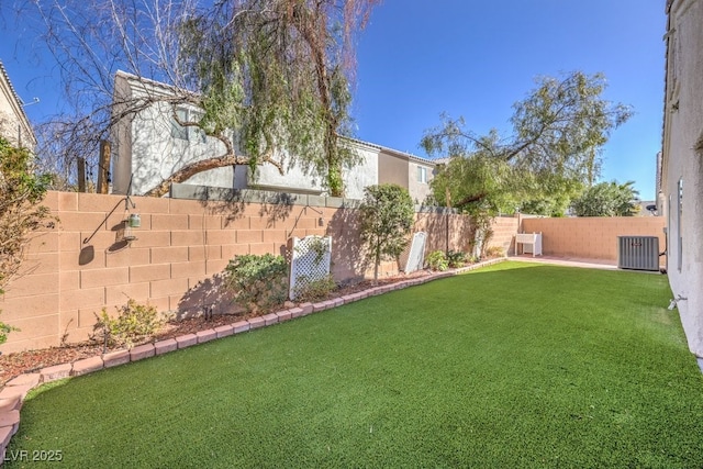 view of yard featuring central air condition unit and a fenced backyard