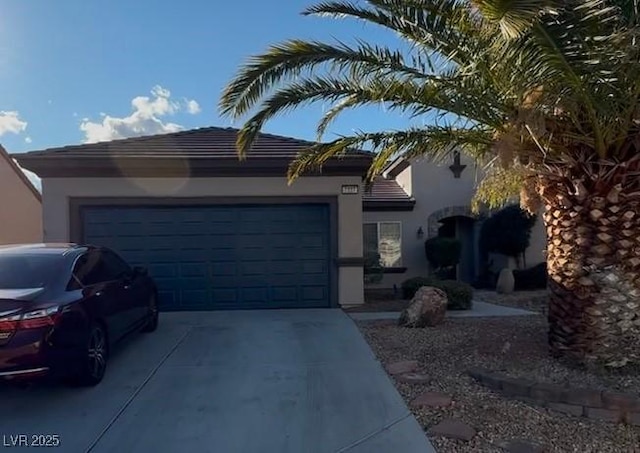 view of front of property featuring a garage, driveway, and stucco siding