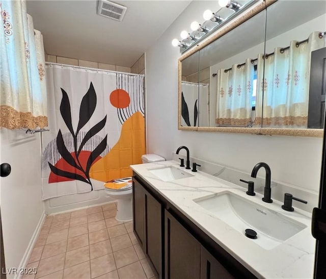 bathroom with toilet, visible vents, a sink, and tile patterned floors