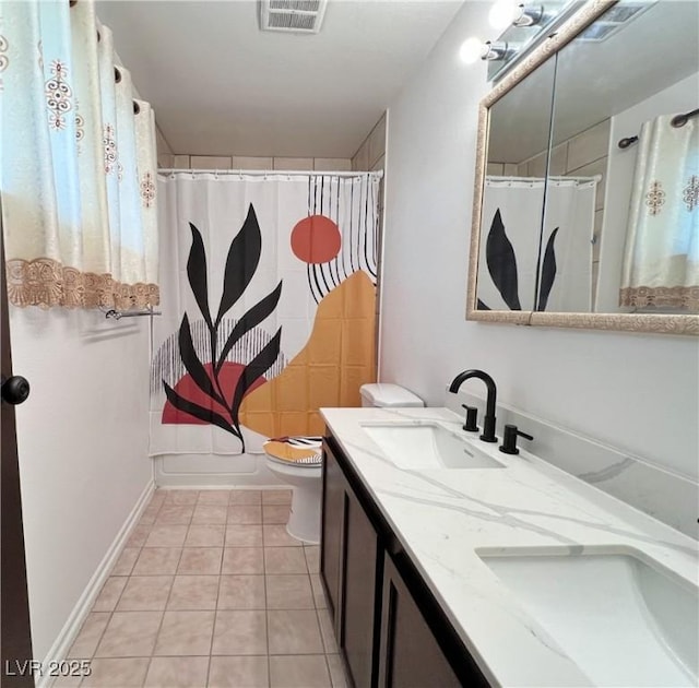 full bathroom featuring double vanity, tile patterned flooring, a sink, and visible vents