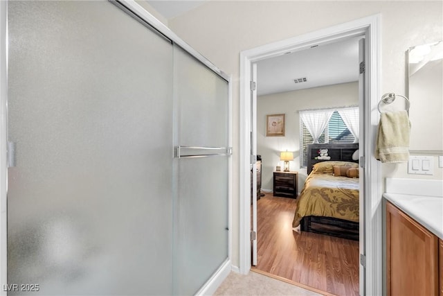 full bath featuring visible vents, ensuite bath, wood finished floors, vanity, and a shower stall