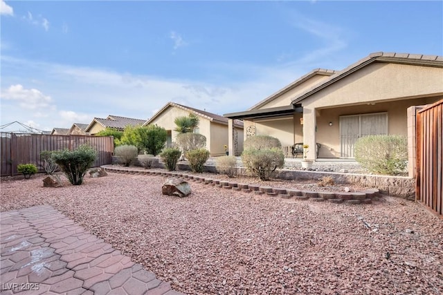 exterior space with fence and stucco siding