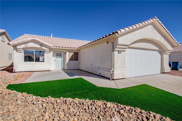 mediterranean / spanish-style home with an attached garage, driveway, a tiled roof, and stucco siding