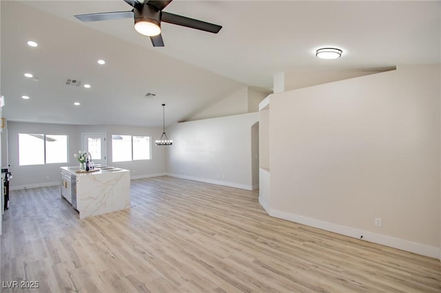 unfurnished living room with lofted ceiling, light wood-style floors, baseboards, and visible vents