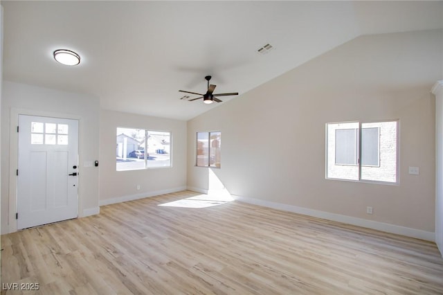 foyer entrance featuring lofted ceiling, light wood finished floors, baseboards, and visible vents