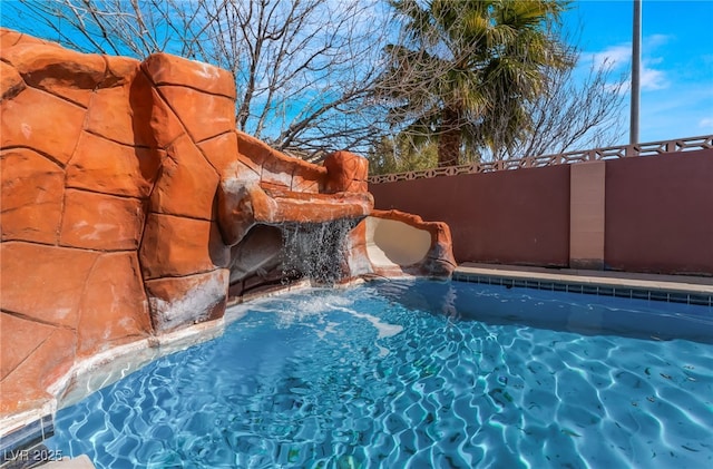 view of swimming pool featuring fence and a fenced in pool