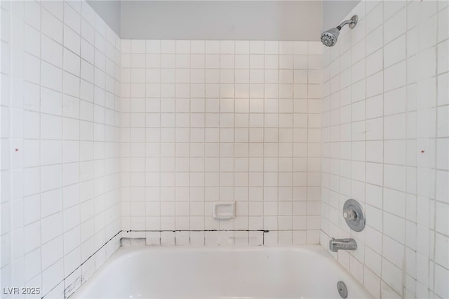 bathroom with bathing tub / shower combination