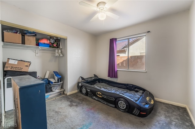 bedroom with ceiling fan, dark carpet, and baseboards