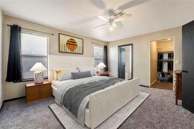 bedroom featuring light carpet, multiple windows, and baseboards