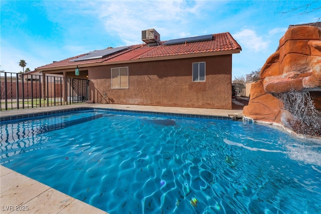 view of swimming pool featuring a fenced in pool, fence, and central AC unit