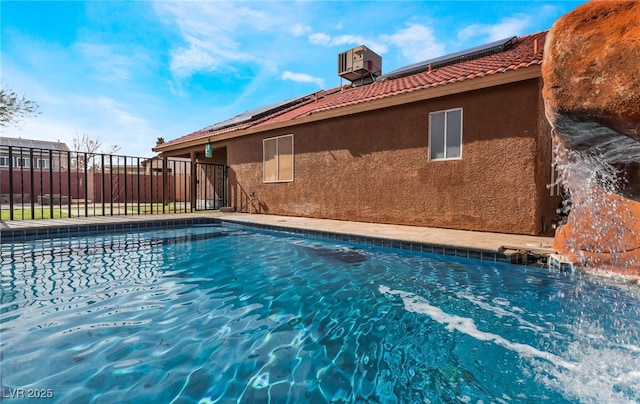 view of swimming pool featuring fence and central air condition unit