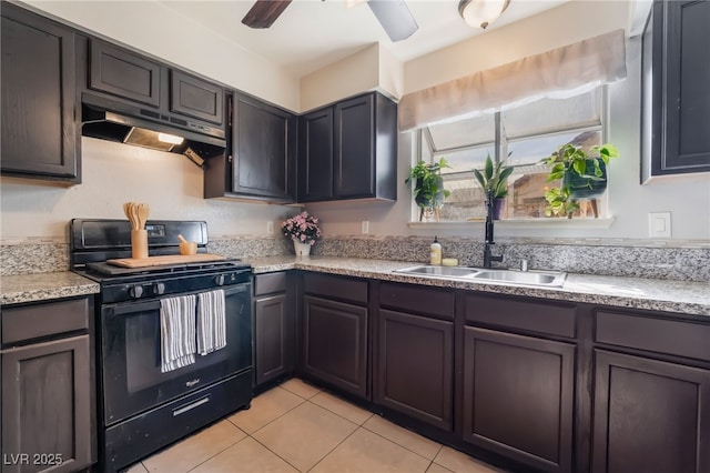 kitchen with a ceiling fan, black range with gas stovetop, under cabinet range hood, a sink, and light tile patterned flooring