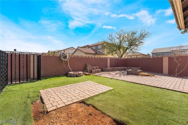 view of yard with an outdoor fire pit, a patio area, and a fenced backyard