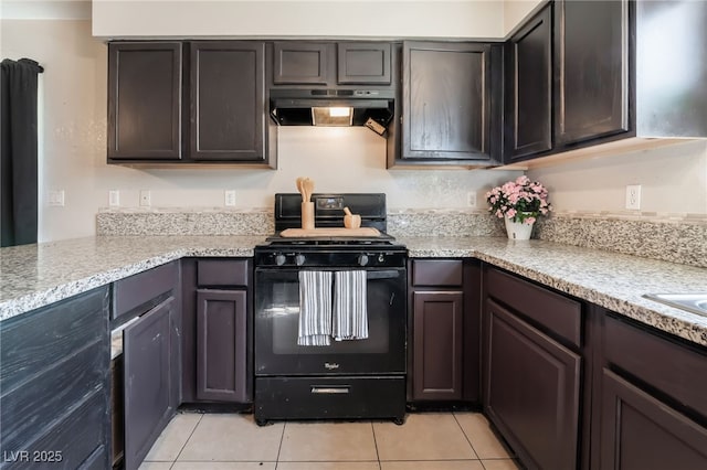 kitchen featuring dark brown cabinetry, under cabinet range hood, and black range with gas stovetop