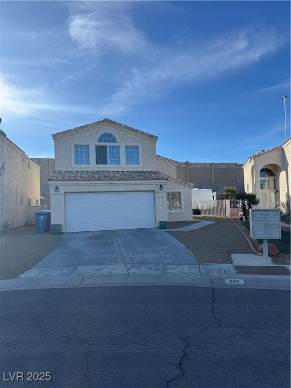 view of front of property featuring a garage, driveway, and stucco siding