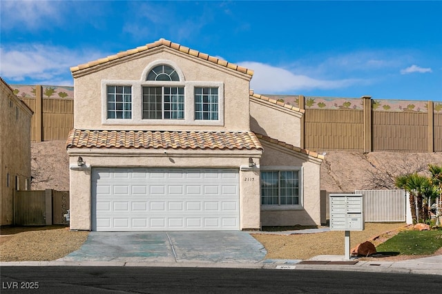 mediterranean / spanish home with a tile roof, fence, driveway, and stucco siding