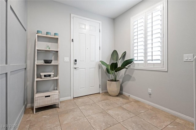 entrance foyer featuring light tile patterned floors and baseboards