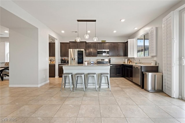 kitchen featuring visible vents, dark brown cabinetry, light countertops, light tile patterned flooring, and stainless steel appliances