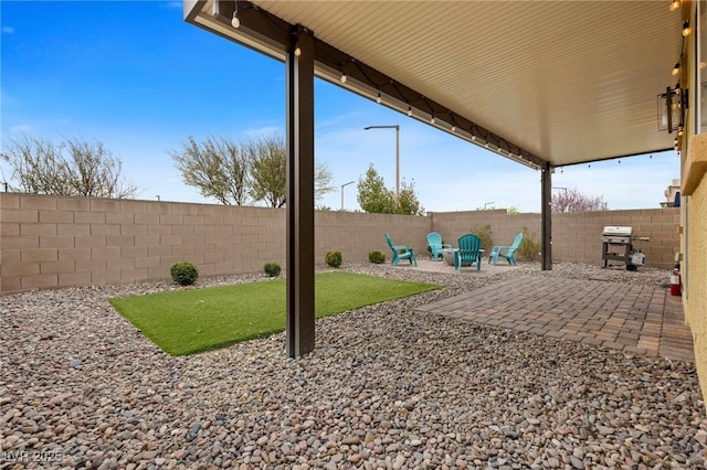 view of yard with a fenced backyard and a patio