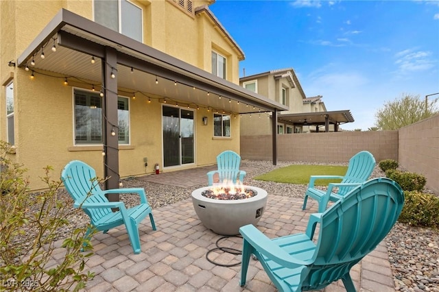 view of patio featuring a fire pit and a fenced backyard