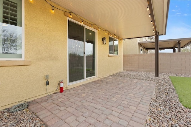 view of patio featuring fence