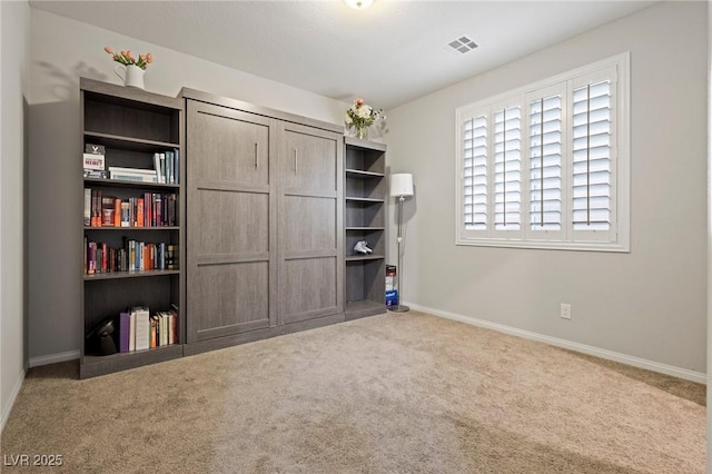 unfurnished bedroom with visible vents, baseboards, and carpet