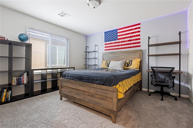 carpeted bedroom featuring baseboards and visible vents