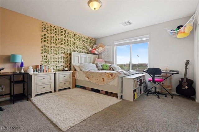 carpeted bedroom featuring visible vents