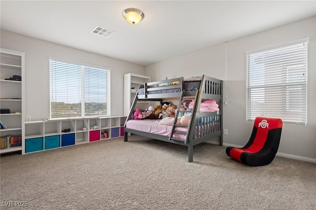 carpeted bedroom featuring visible vents and baseboards