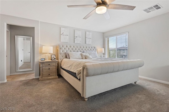 carpeted bedroom with visible vents, baseboards, and a ceiling fan