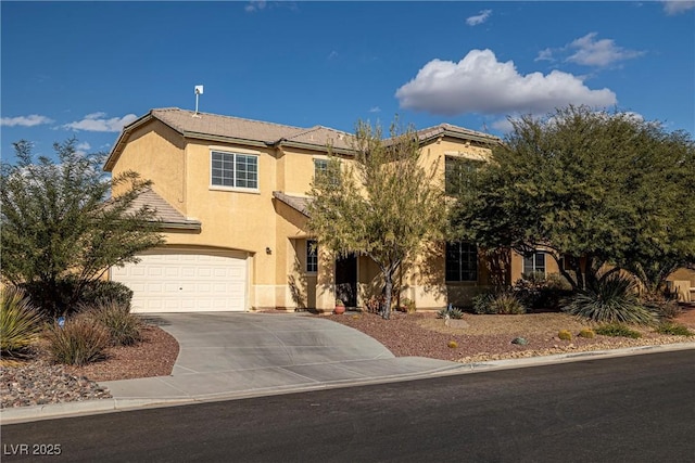 view of front of home featuring a garage, driveway, and stucco siding