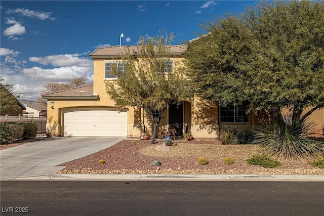 view of front facade with an attached garage, concrete driveway, and stucco siding