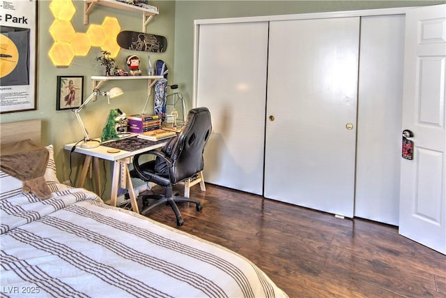 bedroom with dark wood-type flooring and a closet