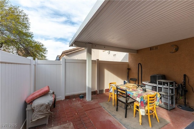 view of patio / terrace featuring a fenced backyard, visible vents, and outdoor dining space