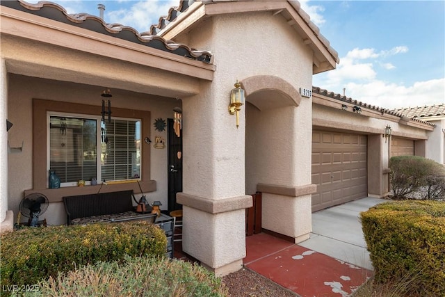 entrance to property with a tiled roof and stucco siding