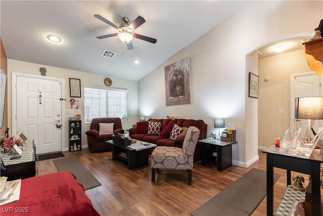 living area featuring arched walkways, lofted ceiling, visible vents, ceiling fan, and wood finished floors