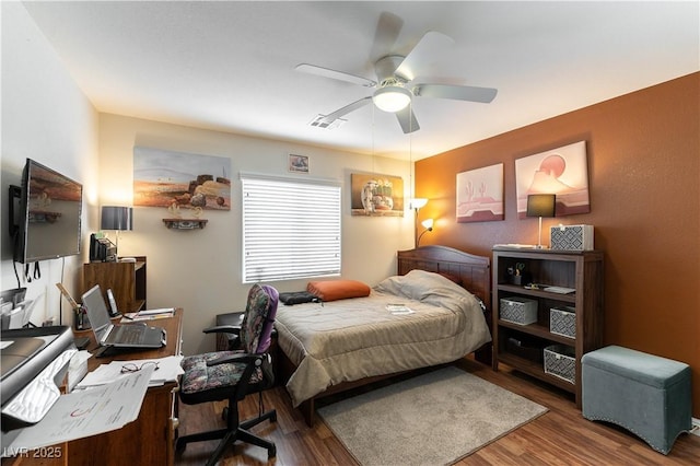 bedroom with ceiling fan and wood finished floors