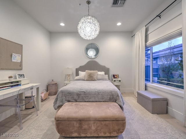 bedroom with a notable chandelier, visible vents, and recessed lighting